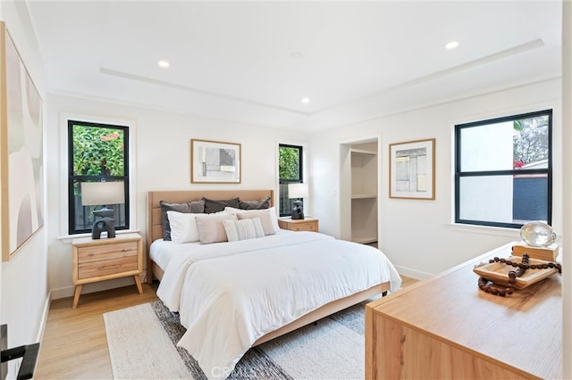 bedroom featuring light hardwood / wood-style floors and multiple windows