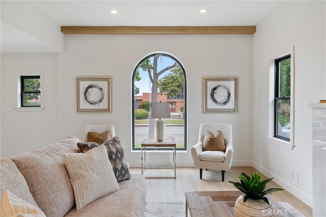 living room with light wood-type flooring and beamed ceiling