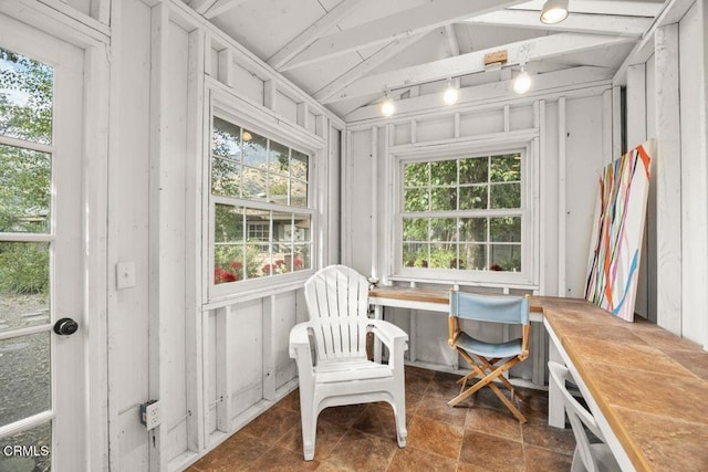 sunroom / solarium featuring lofted ceiling