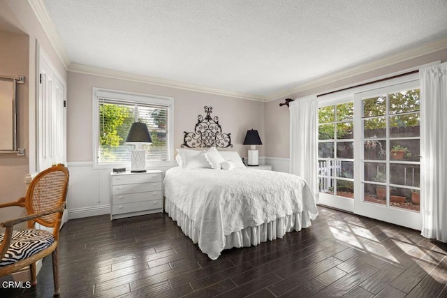 bedroom featuring a textured ceiling, dark hardwood / wood-style flooring, and crown molding