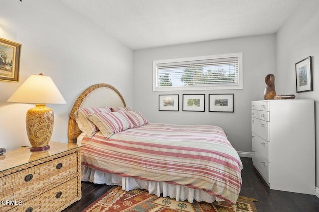 bedroom with dark wood-type flooring