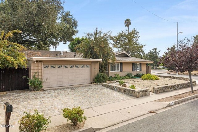 617 Pleasant Ave, Ojai, CA 93023 - ranch-style house with decorative driveway, stucco siding, fence, and an attached garage