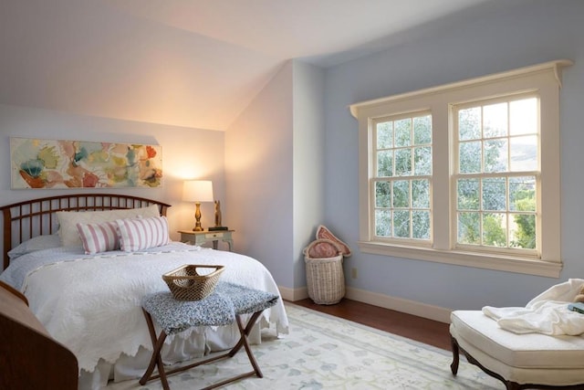 bedroom featuring lofted ceiling and hardwood / wood-style flooring