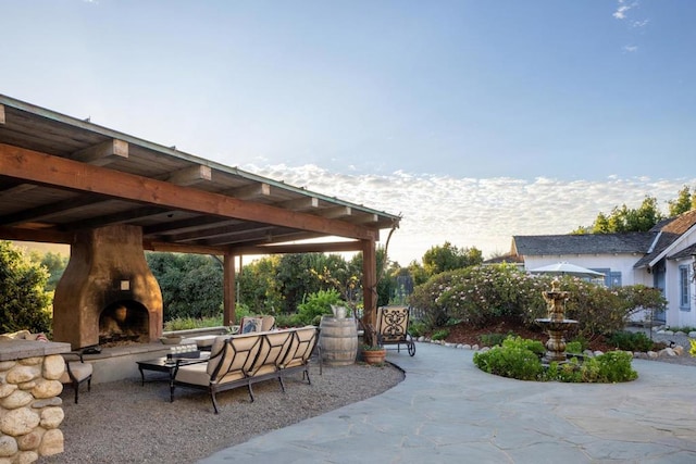 view of patio with an outdoor fireplace