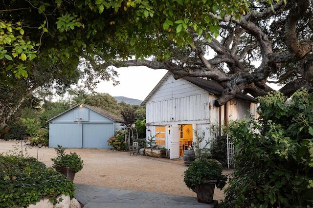 view of side of home with an outdoor structure