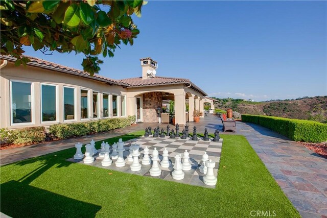 26088 Calle Catrina, Temecula, CA 92590 - back of property featuring a chimney, stucco siding, a yard, and a tile roof