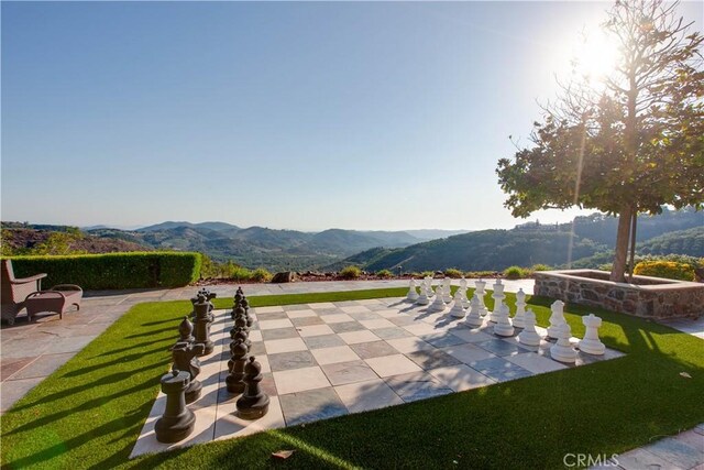 surrounding community with a patio area and a mountain view