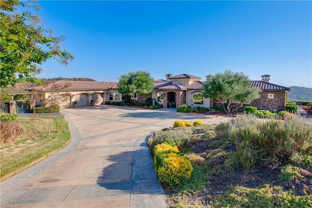 26088 Calle Catrina, Temecula, CA 92590 - mediterranean / spanish house featuring a tile roof, driveway, a garage, and stucco siding