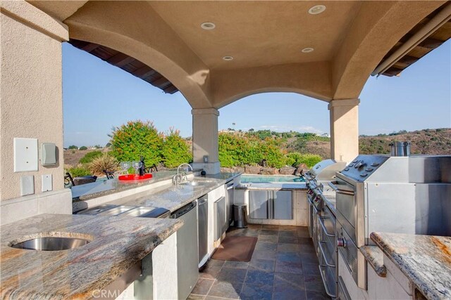 view of patio / terrace with exterior kitchen and sink