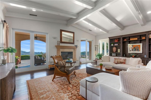 living room featuring a mountain view, ceiling fan, dark hardwood / wood-style flooring, french doors, and lofted ceiling with beams