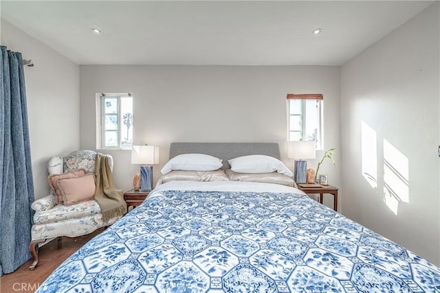 bedroom featuring multiple windows and hardwood / wood-style floors