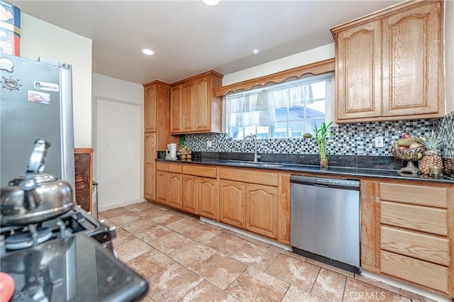 kitchen with tasteful backsplash, sink, and appliances with stainless steel finishes