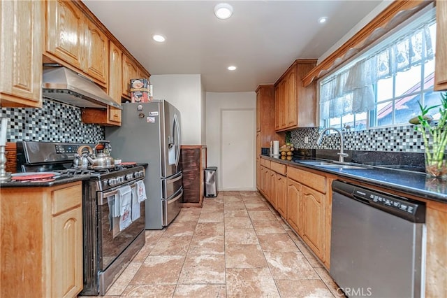 kitchen with dark stone counters, decorative backsplash, sink, and stainless steel appliances