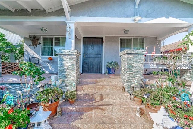 entrance to property featuring covered porch