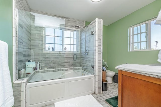 bathroom with shower / bath combination with glass door and toilet