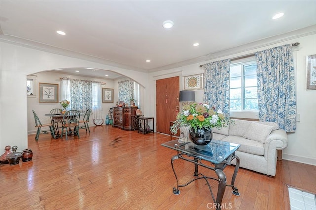 living room featuring hardwood / wood-style flooring and crown molding