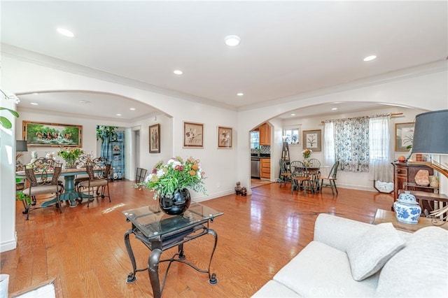 living room with crown molding and hardwood / wood-style flooring