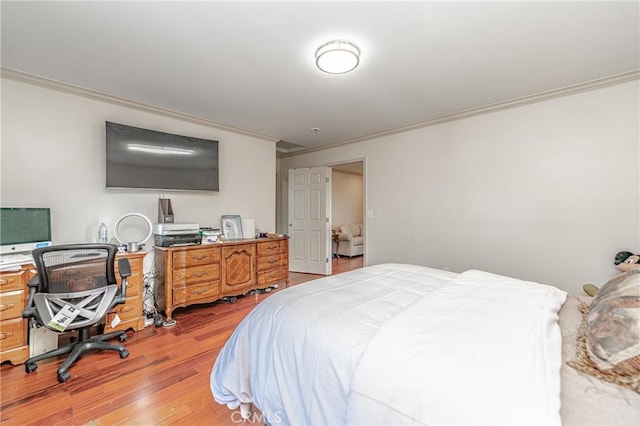 bedroom with light hardwood / wood-style flooring and crown molding