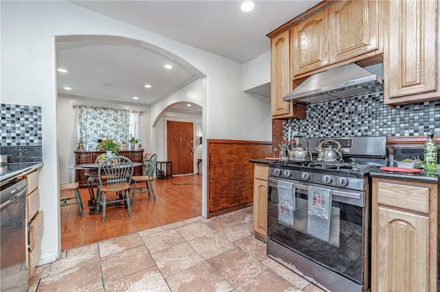 kitchen featuring stainless steel appliances, extractor fan, tasteful backsplash, and light hardwood / wood-style flooring