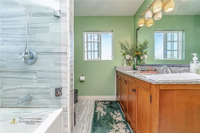 bathroom with vanity, independent shower and bath, and a wealth of natural light