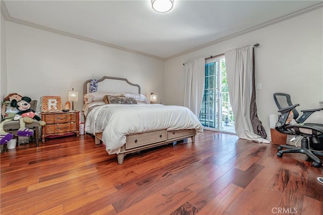 bedroom with hardwood / wood-style floors, access to exterior, and crown molding