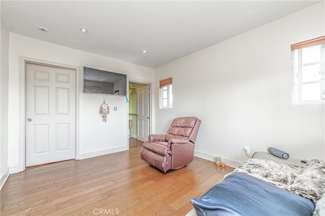 bedroom featuring light hardwood / wood-style flooring and multiple windows