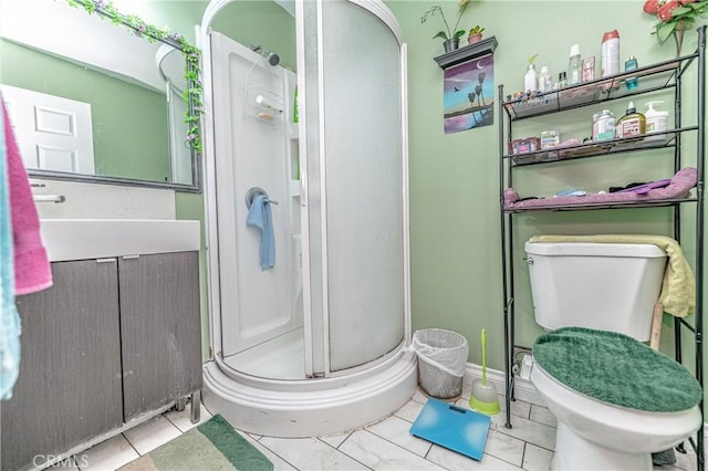 bathroom featuring walk in shower, tile patterned floors, vanity, and toilet