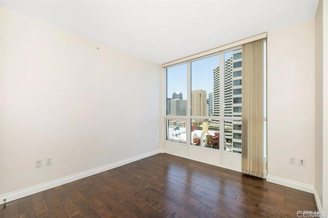 spare room featuring dark hardwood / wood-style flooring