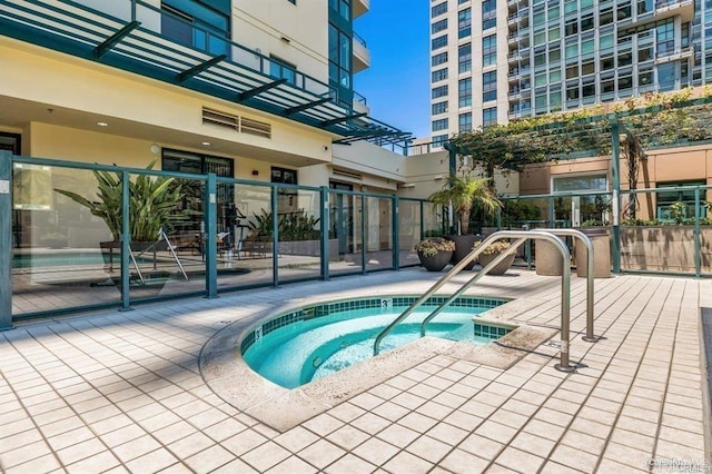 view of swimming pool featuring a hot tub