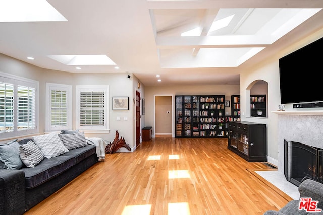 living room with light wood-type flooring and a fireplace