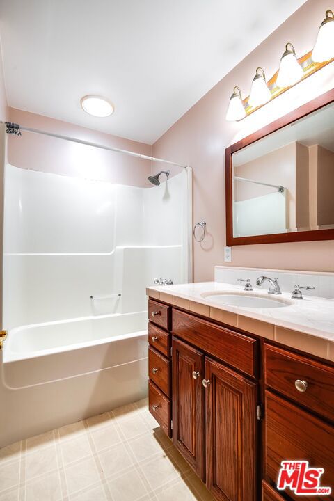 bathroom with vanity and tub / shower combination