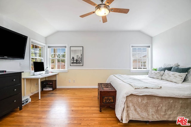 bedroom with light hardwood / wood-style floors, vaulted ceiling, and ceiling fan