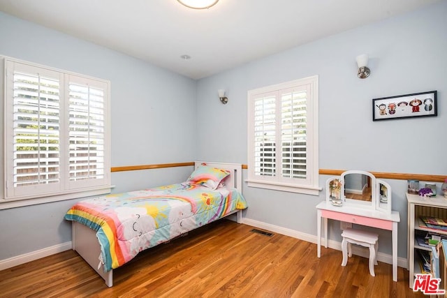 bedroom with hardwood / wood-style flooring