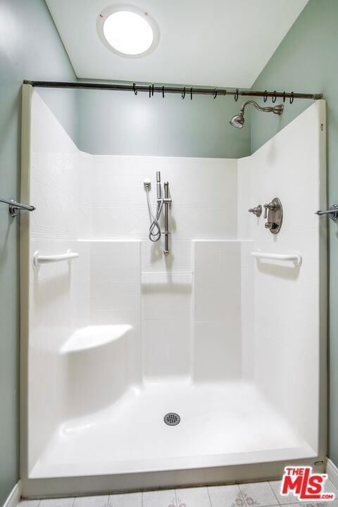 bathroom featuring tile patterned flooring and walk in shower