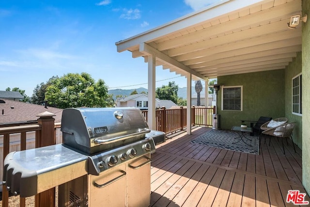 wooden deck featuring area for grilling