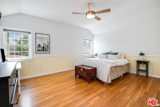 bedroom with hardwood / wood-style floors, ceiling fan, and multiple windows