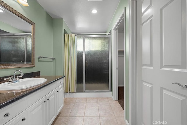 bathroom featuring tile patterned flooring, vanity, and an enclosed shower