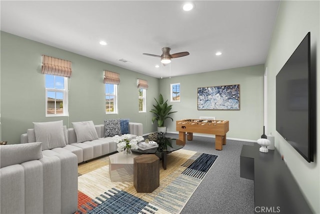 carpeted living room with ceiling fan