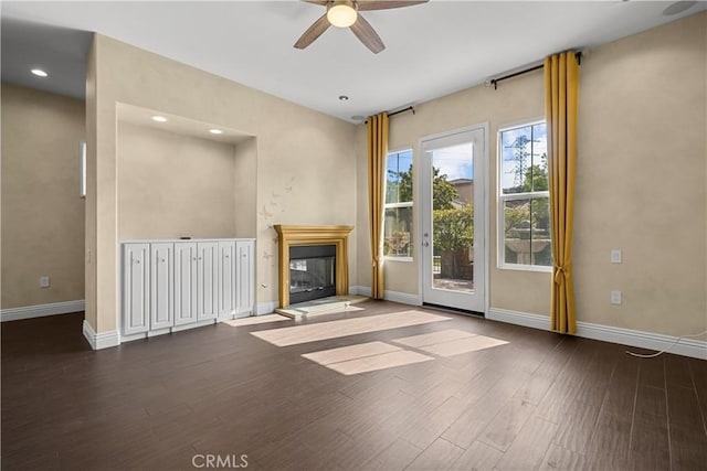 unfurnished living room with ceiling fan and dark hardwood / wood-style floors