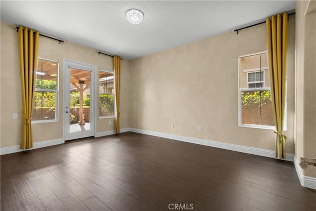 empty room with dark hardwood / wood-style floors