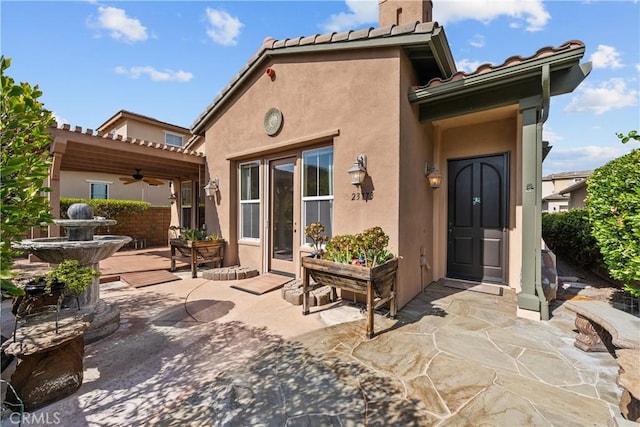 rear view of house featuring a patio and ceiling fan