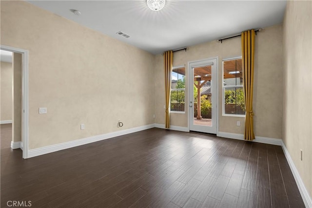 spare room featuring dark hardwood / wood-style flooring