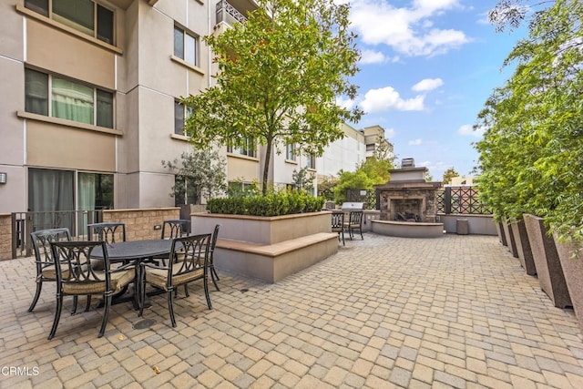 view of patio / terrace featuring an outdoor fireplace