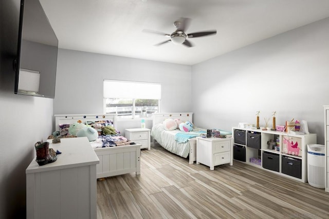 bedroom with ceiling fan and light wood-type flooring