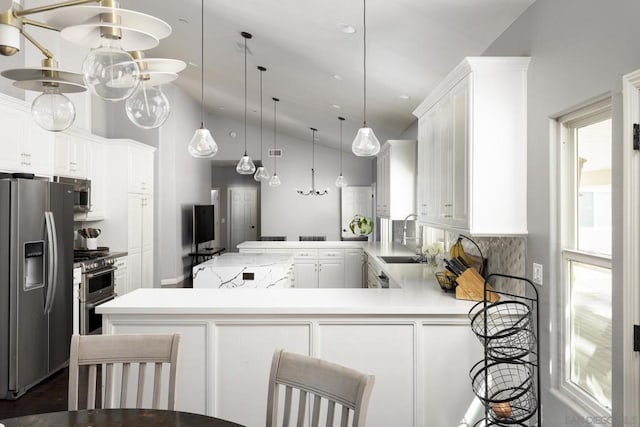 kitchen featuring stainless steel appliances, pendant lighting, white cabinets, and kitchen peninsula