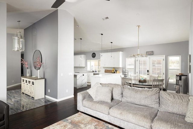 living room featuring dark wood-type flooring and sink