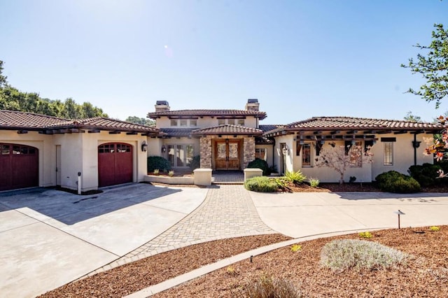 mediterranean / spanish house featuring a garage