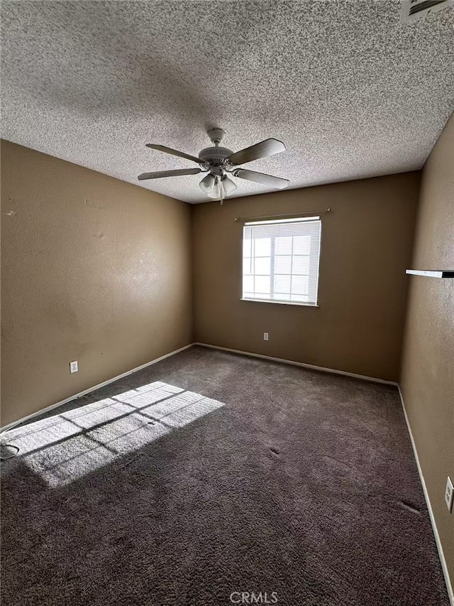 carpeted empty room with a textured ceiling and ceiling fan