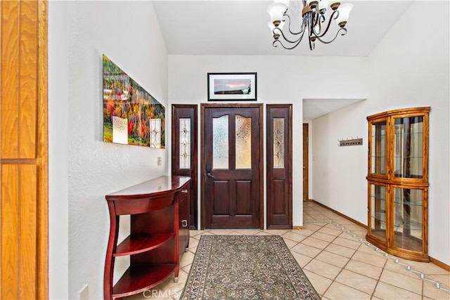 tiled entrance foyer with an inviting chandelier