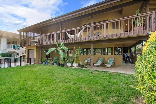 back of house with a patio area and a yard